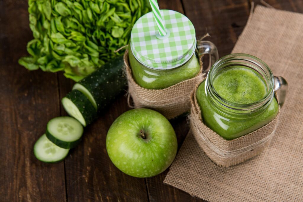 2 green smoothies with a cucumber and green apple