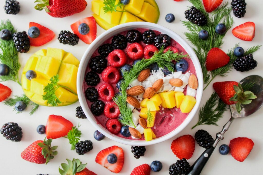Colorful fruit mix in and out of a bowl