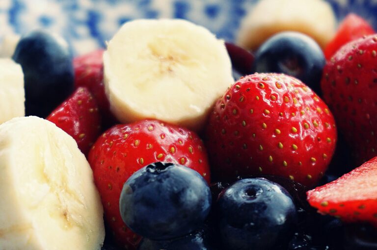 Sliced banana with blueberries and strawberries