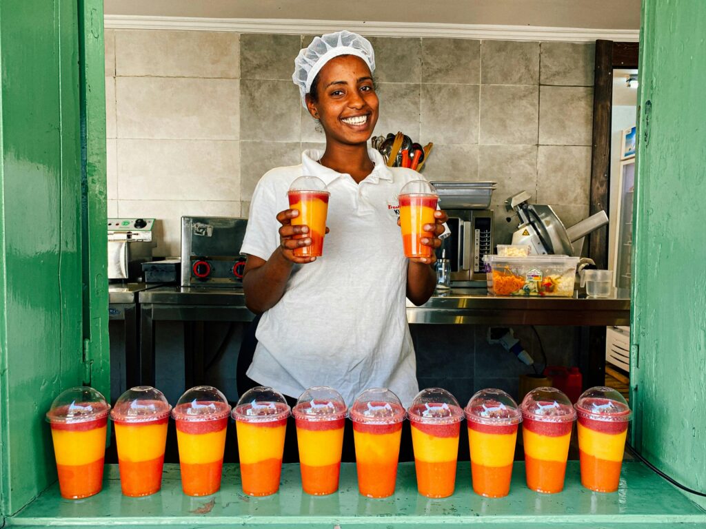 a lady showing off smoothies