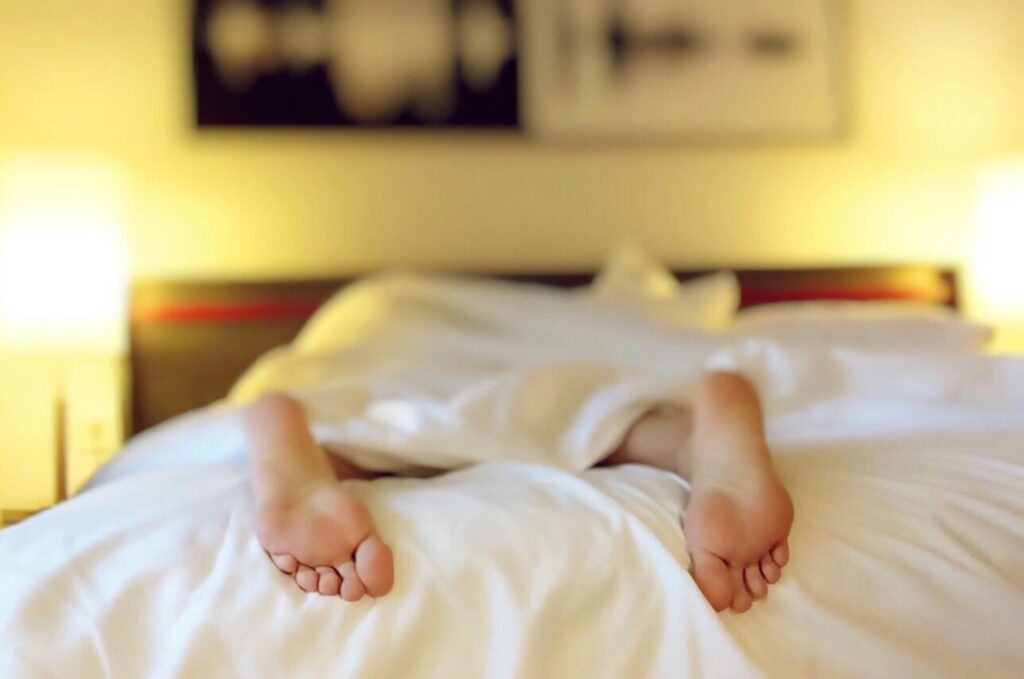 Boost metabolism in your 30 with sleep - feet in a bed