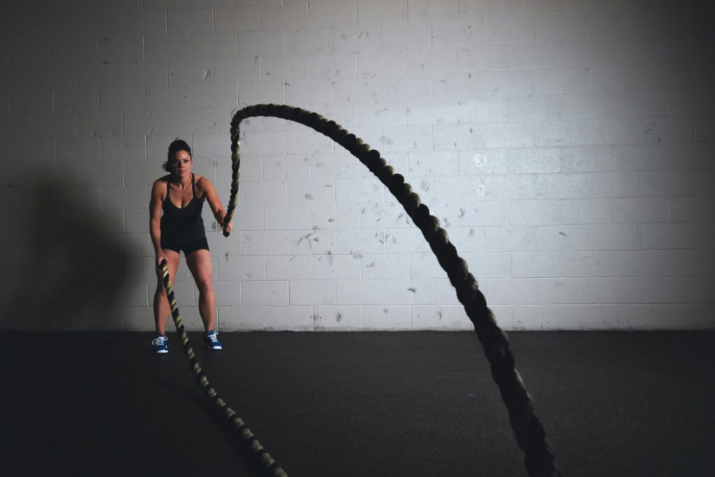 Boost metabolism in your 30s - a woman moving exercise ropes