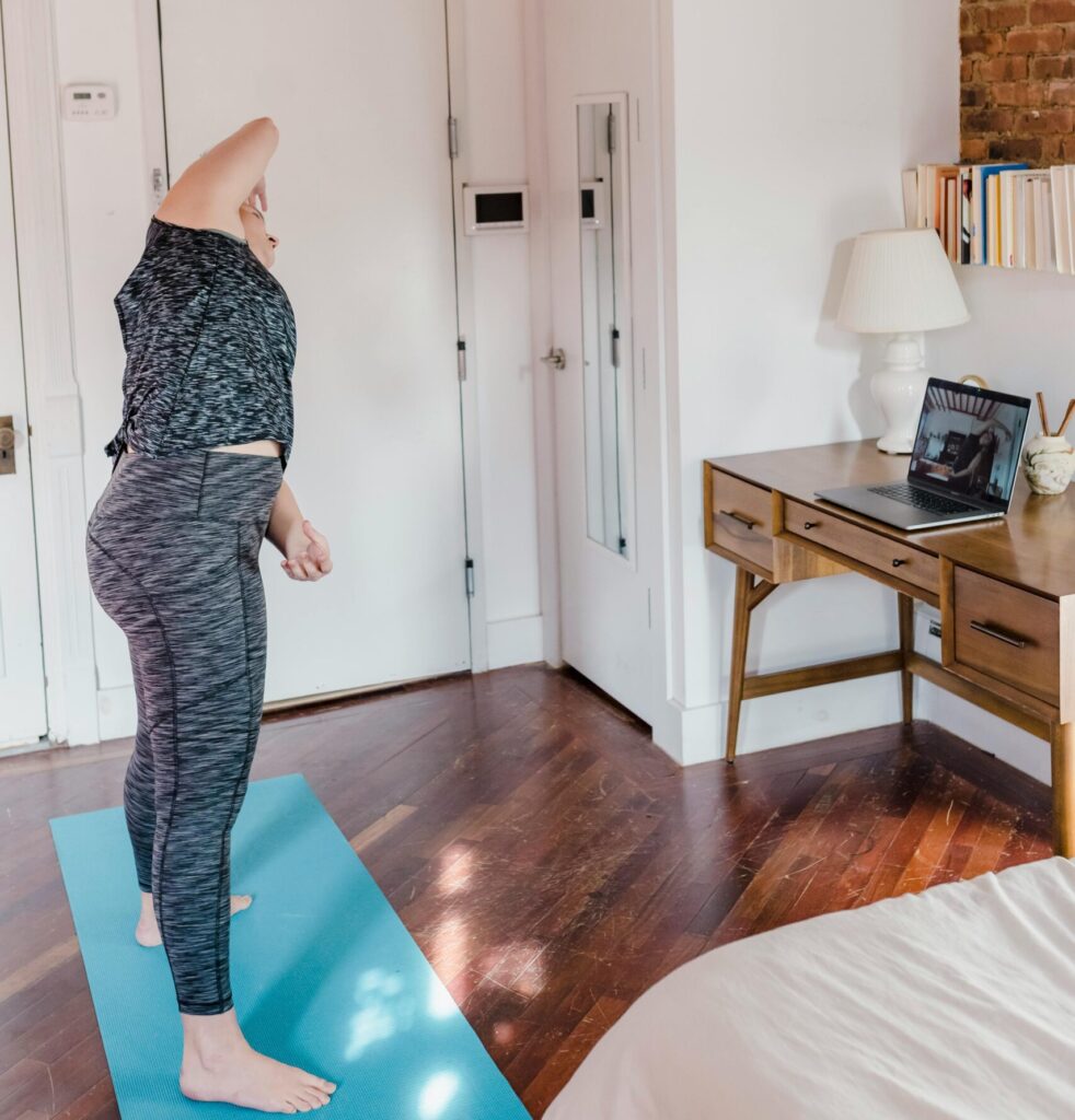 woman stretching in bedroom